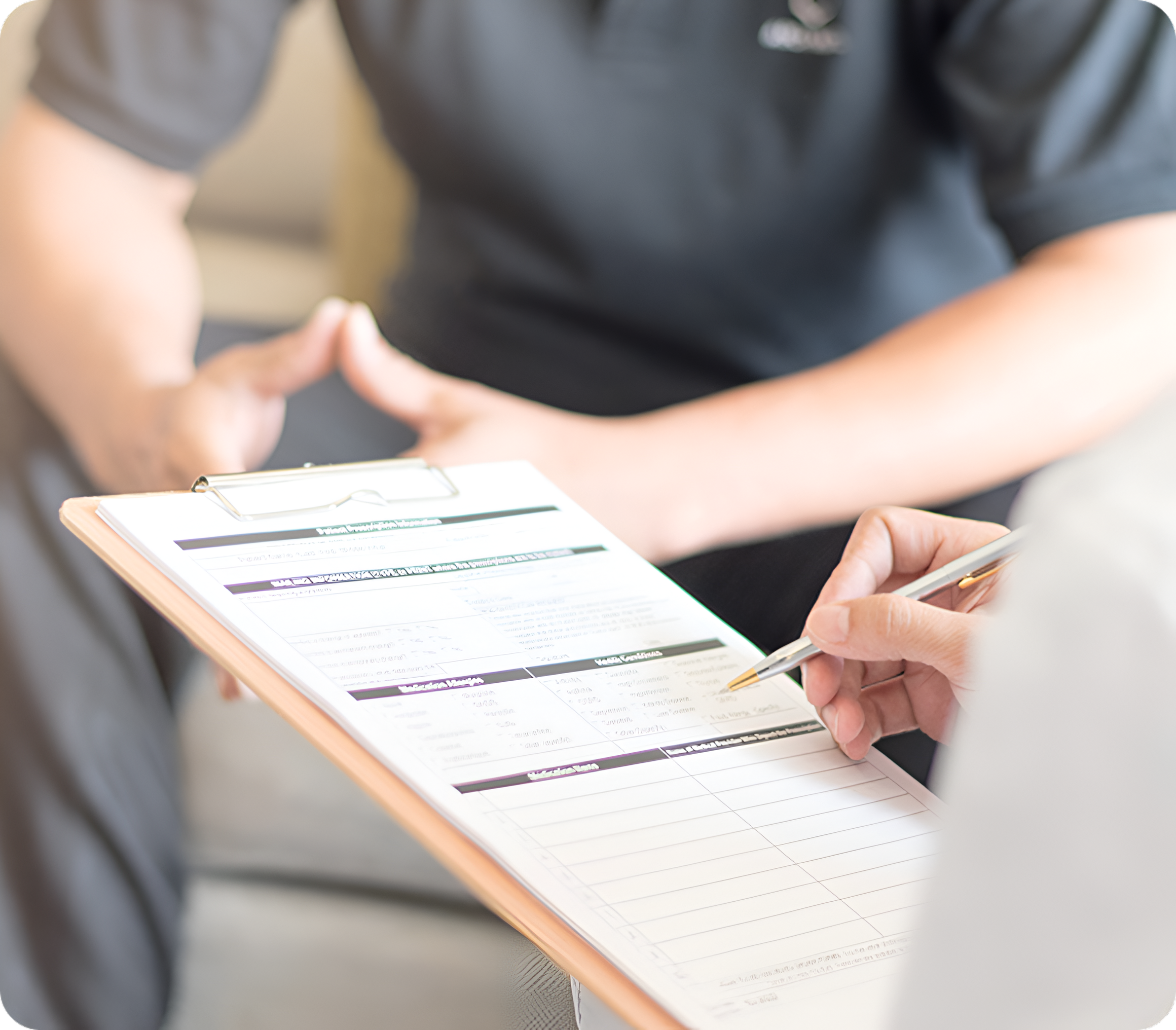 Person filling out a clipboard form.