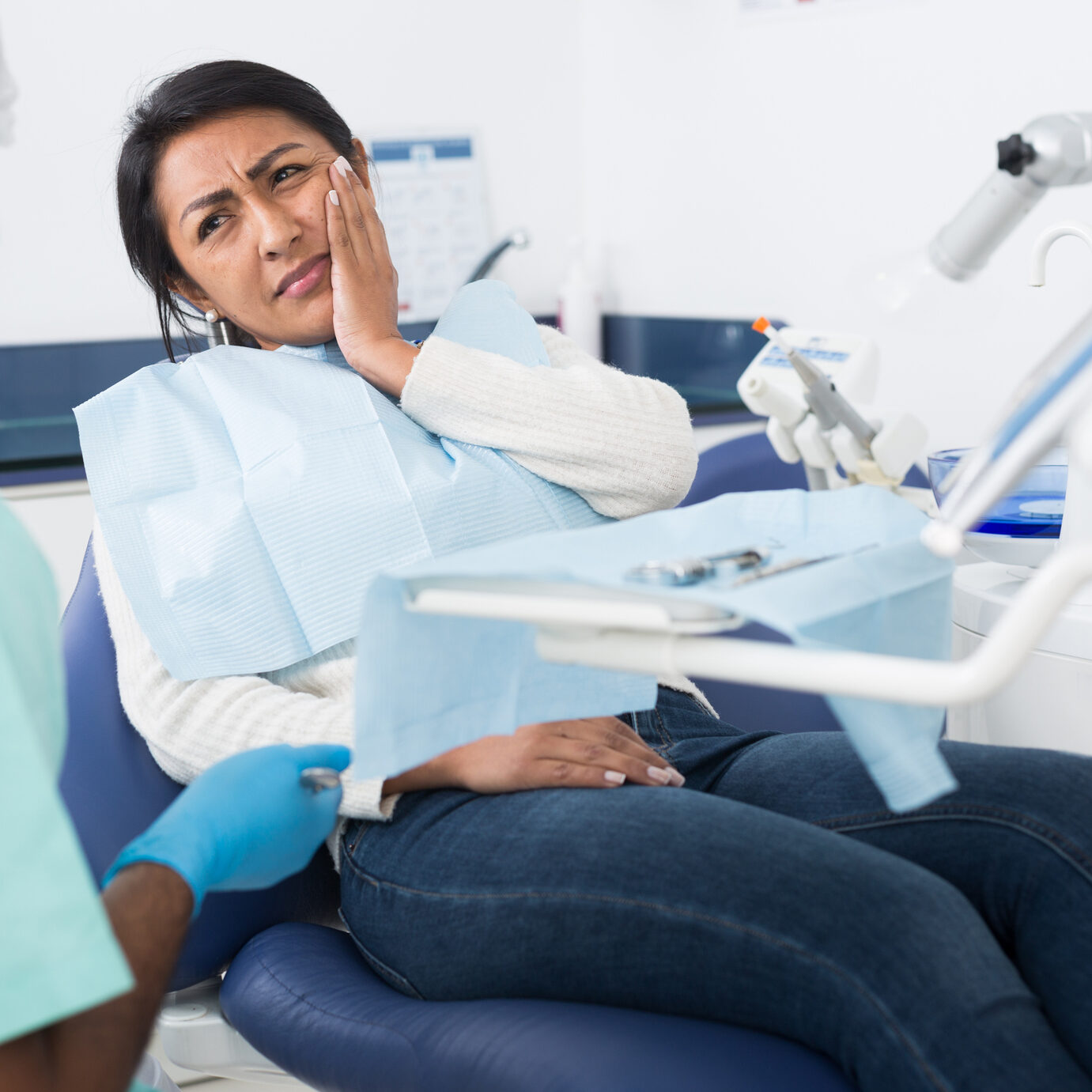 Woman with toothache in dental chair